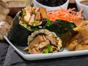 Saucy Tofu Roll: Ginger braised tofu, avocado, crispy wonton crisps, shredded carrots, organic field greens and black bean sauce at Yugo in Miami