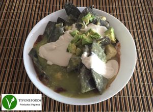 Tivoni Foods vegan Chilaquiles made with blue corn tortilla green tomato sauce cashew manchego, cashew sour cream and avocado at Tivoni Foods in Mexico City