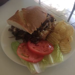Vegan philly steak sandwich with lettuce, tomato & chips at Loving Hut in Fresno