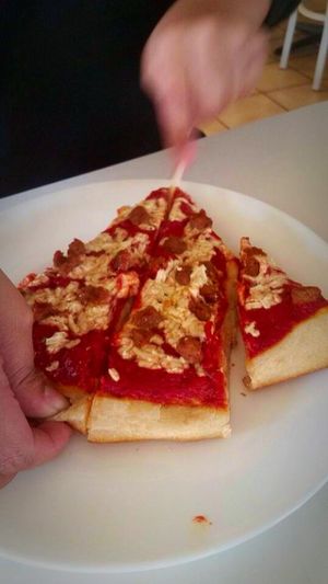 1 slice vegan. With mock sausage (fool any meat eater with this meatless option)  sorry was in the process of cutting but that's 1 slice :) love it at Loving Hut in Fresno