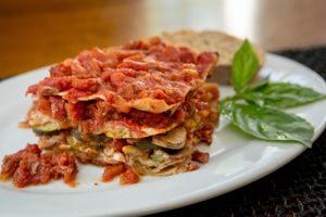 Fred & Ricky’s take on classic lasagna where whole wheat noodles are layered with a rich, chunky tomato sauce, earthy sun dried tomatoes and a mushroom, zucchini, onion, tofu mixture that provides plenty of non-cheesy richness. at Fred and Ricky's Plant Delicious Foods - Westport in Maryland Heights
