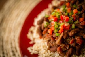 In order to give Fred Beans & Brown Rice a rich savory taste without meat, Fred uses a unique blend of vegetables, herbs and spices cooked together slowly for hours, served over a bed of brown rice, and topped with a spicy Sofrito garnish. at Fred and Ricky's Plant Delicious Foods - Westport in Maryland Heights