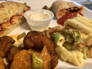 Chicken parm sandwich, mushroom sausage calzone, Demons (buffalo cauliflower wings (came with ranch)), and fire proof (mac n cheese w/ jalapeño and fried onion). Delicious!!  at Mozzarella Fellas in Winston-salem