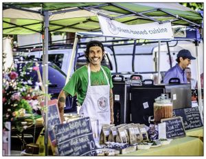 Chef Matteo Silverman serving food at the Sebastopol Farmer's Market Stand. Find Sunflower Veggie Burgers, Cashew Cheese Ravioli, Dark Chocolate Macaroons, Coconut Milk Chai and more  at Chalk Hill Cookery in Healdsburg
