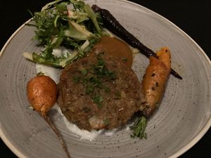 Lentil kefta with honey crisp apple butter, dill infused coconut yogurt, curried baby carrots, grilled romaine, and pickled okra at Harvest Beat in Seattle
