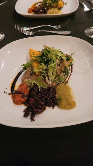 Crispy polenta with elderberry braised red cabbage, wild mushroom-leek crème, green tomato jam, finished with an ancho chili-sundried tomato compote. at Harvest Beat in Seattle