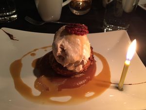 Stuffed apple with ice cream and pecans with my birthday candle  at Harvest Beat in Seattle