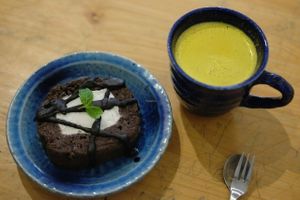 daily bakery / chocolate cake with ice cream on the inside with a cup of turmeric ginger tea at La Studio in Hanoi