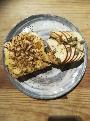 Fruit Toast- Homemade bread, toasted,  with homemade peanut butter, banana, walnuts  and chocolate flakes on one piece, and pb, apple and cinnamon on the other. So good :)  at La Studio in Hanoi