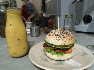 Tempeh bagel and mango banana passion fruit smoothie. at La Studio in Hanoi