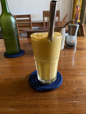 Atomic bomb smoothie and water in background  at Simple Things in Kampot