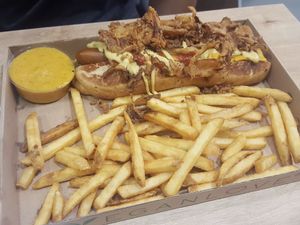 Onion dog with an order of fries and vegan cheese sauce at Vegan Love in Budapest