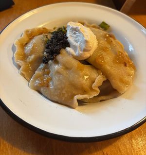 Pierogi z Ziemniakami (boiled potato and cabbage pierogi with onion, double fat, cabbage, dill, and czarna salsa) at Apteka in Pittsburgh