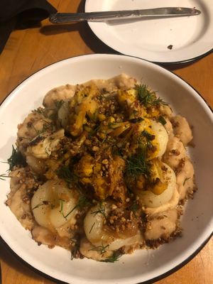 Kluski Slaskie (Silesian potato dumplings with slow cooked giant runners, celeriac root purée, caramelized onion, cauliflower, sunflower seed, scallion, fried buckwheat, and dill) at Apteka in Pittsburgh