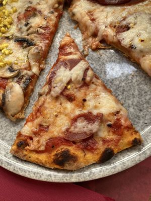 Pizza capricciosa slice at Rifugio Romano in Rome