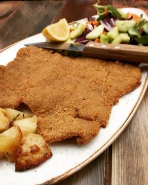 Vegan and homemade seitan cutlet with mixed salad and roasted potatoes at Rifugio Romano in Rome