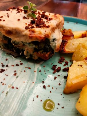 Tempeh with chicory, black olives and cashew besciamella at Rifugio Romano in Rome