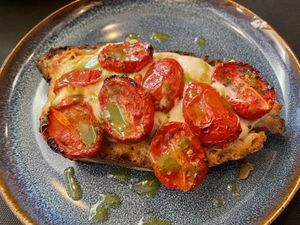 Bruschettone primo sale di anacardi, pomodori datterini confit, riduzione di basilico e origano  at Rifugio Romano in Rome