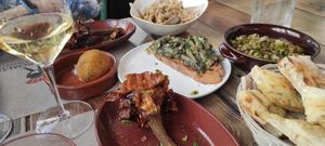Focaccia, carciofo alla giudia, bruschetta con carciofo alla romana, suppli, e moscardini di funghi (top) at Rifugio Romano in Rome