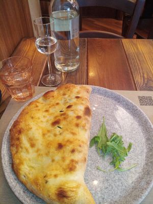Calzone, vegan chicken alla Romana, grappa and qr code for the menu at Rifugio Romano in Rome