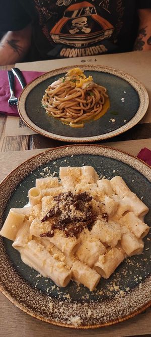 Mezze maniche alla Gricia and tonello all'aglio nero e fiori di zucca at Rifugio Romano in Rome