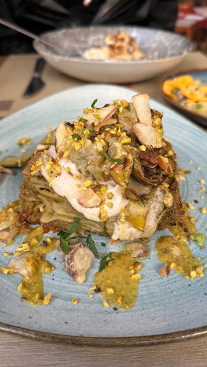 Lasagna with pistachio and artichoke, homemade jerusalem artichoke bechamel sauce and chips at Rifugio Romano in Rome