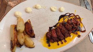 Vegetable Sliced "Meat" Served on Carrot Cream, Balsamic Vinegar Reduction Flavored with vegan mayo and potatoes at Rifugio Romano in Rome