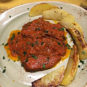 Seitan escalopes with tomato (pizza) sauce and potato wedges. at Rifugio Romano in Rome