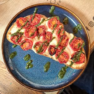 Bruschettone primosale di anacardi, pomodori datterini confit, riduzione di basilico e origano at Rifugio Romano in Rome
