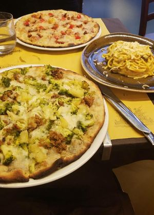 vegan Pizza with 4 different kinds of cheese and sausage, vegan Pizza with broccoli, potatoes, "meat" and mozarella and vegan Carbonara! at Rifugio Romano in Rome