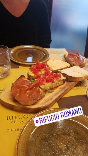 mixed Bruschetta plate with hummus, different spreads and vegan ham, it was amazing! at Rifugio Romano in Rome
