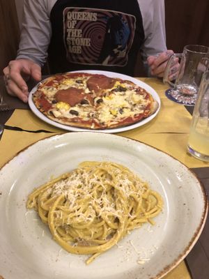 Vegan carbonara and a vegan meaty, cheesy pizza at Rifugio Romano in Rome