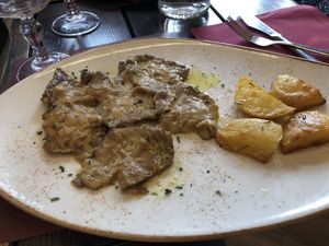Seitan escalopes with potato wedges at Rifugio Romano in Rome