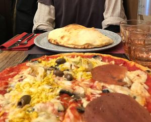 tofu, vegan cheese, fake ham, olive, artichoke pizza and calzone at Rifugio Romano in Rome