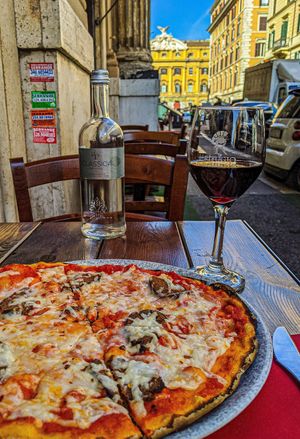 Diavola pizza with a glass of vegan Piceno Ciu Ciu. at Rifugio Romano in Rome