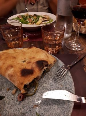 Incredible calzone, salad in the background at Rifugio Romano in Rome