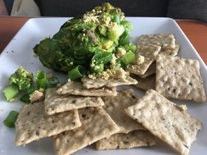 Smokey avocado dip with cashew cheese crumbles and rice crackers! at Cafe Wylde in Everett
