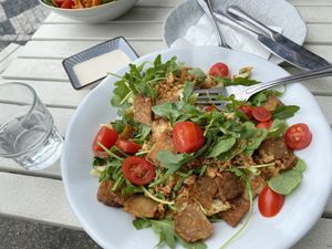 Creamy Penne with tempeh, arugula & tomato at Herbivore in Prague