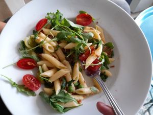 Penne with baked tempeh, peas in cream sauce, cherry tomatoes, rocket at Herbivore in Prague