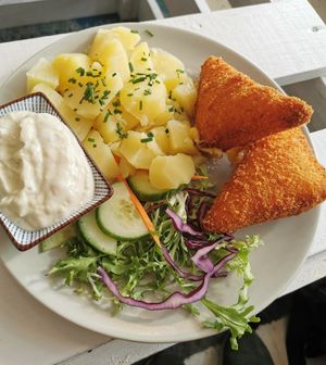 Coated fried vegan cheese with potatoes at Herbivore in Prague