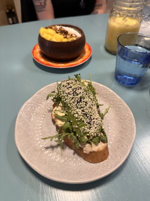Açaí bowl and avocado „toast” with tropical fruits smoothie and detox juice.  at Herbivore in Prague