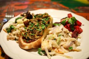pulled oyster mushroom hot-dog, rice noodles with tofu, beetroot-pineapple salad at Herbivore in Prague