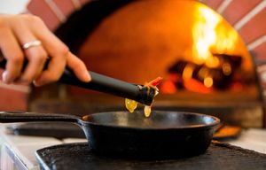Shakshuka preparation at Pitarija Fire Place in Vilnius