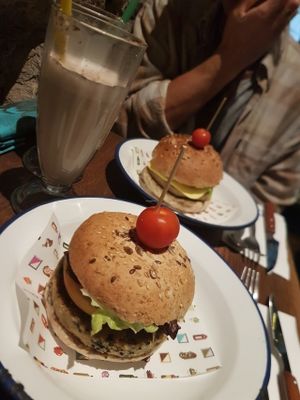 veggie burgers and chairs latte  at Teresa's Juicery in Barcelona