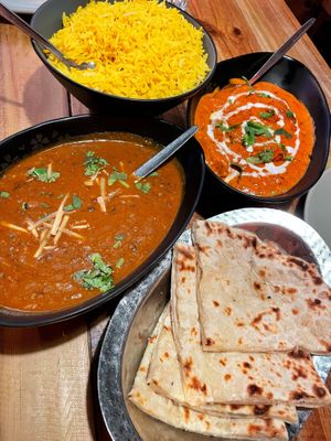 Yellow rice, butter chick’n, dal makhani, cheezy garlic naan 🤤  at Temple of Spices in Mermaid Beach