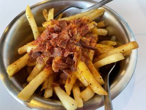 Loaded fries with cheese and bacon  at Comet 984 in Playa Del Carmen