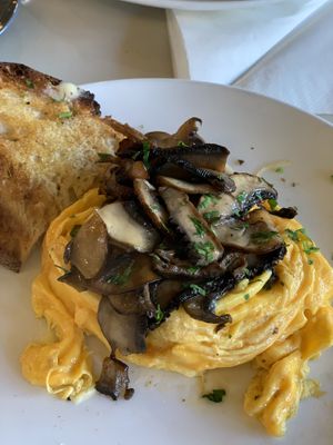 Scrambled egg, topped with portobello mushroom cooked in garlic butter, along with two slices of sourdough!  at Buhler & Co in East London