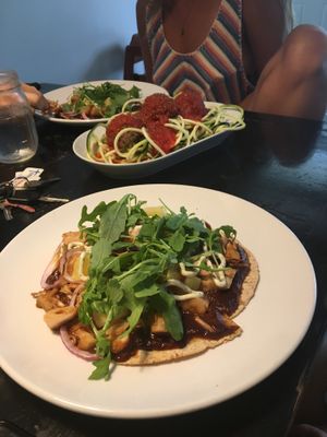 Pizza in the foreground with eggplant meatballs in the background at goodbeet in Haddon Township