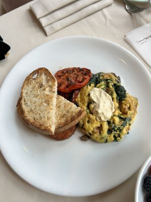Just egg, tempeh bacon, spinach, mushrooms, vegan cheese scramble with charred tomato, delicious potato croquette, and toastted  at Wynn Hotel - Tableau in Las Vegas