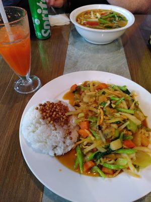 Daily menu (front) and freshly made carrot juice at Buddha Belly in Cat Ba